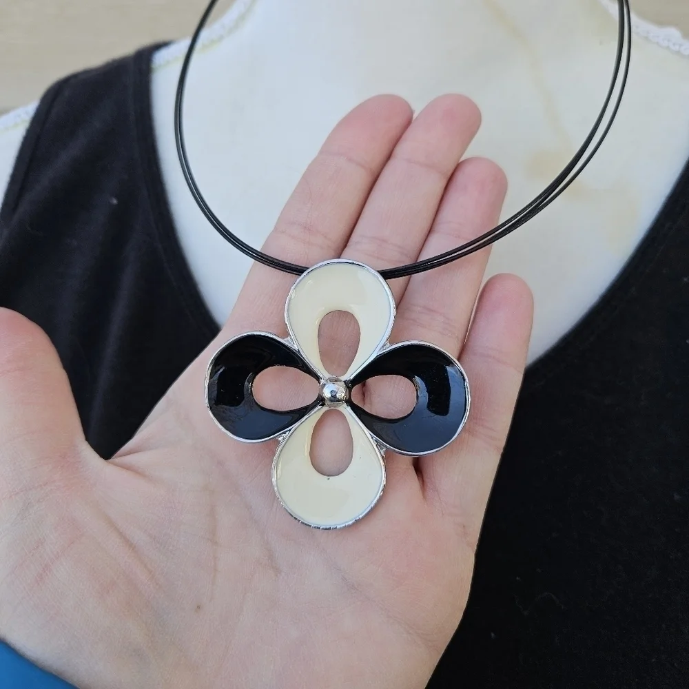 black and cream quatrefoil pendant necklace on black cord